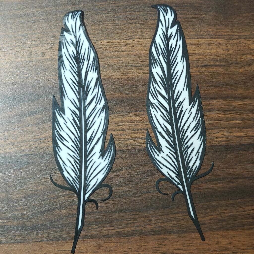 3D printed feather-shaped bookmarks in black and white