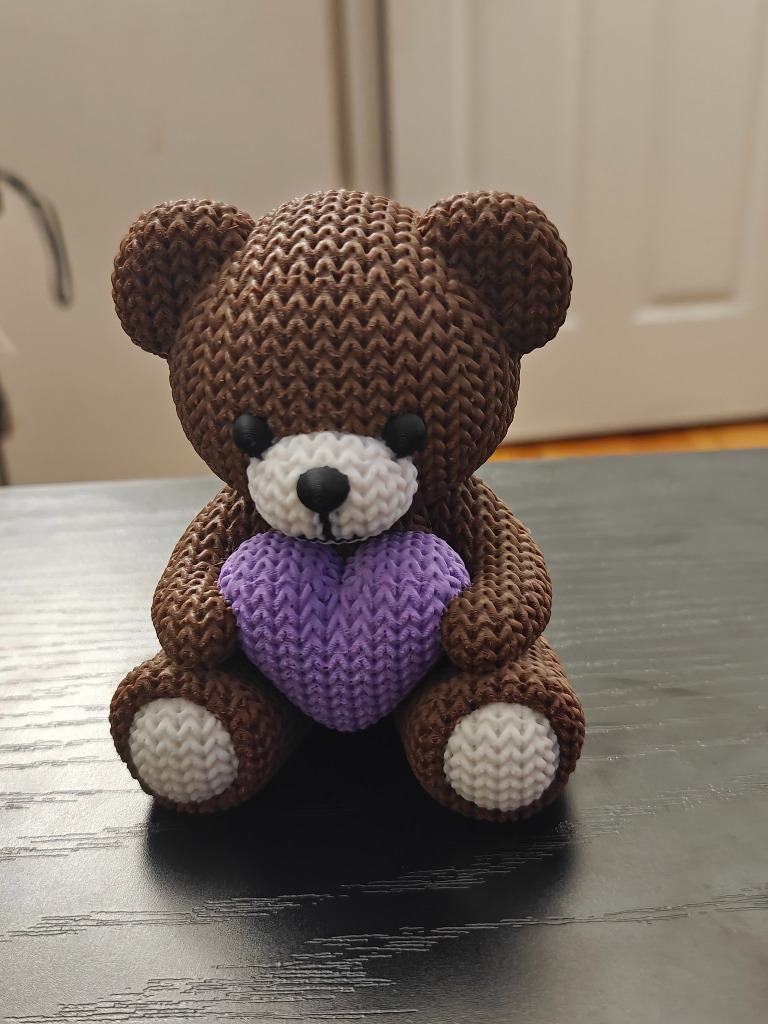 3D printed knitted-style teddy bear holding purple heart