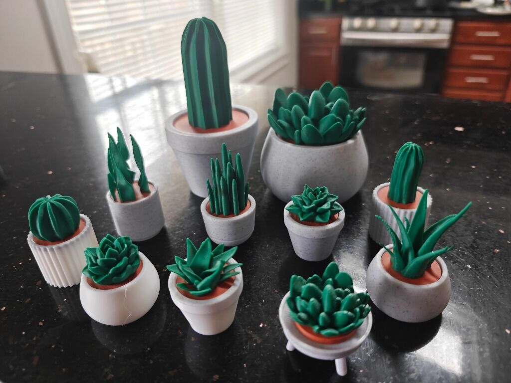 Collection of 3D printed mini succulent plants in decorative pots